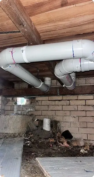 Bell Plumbing pipework under a house